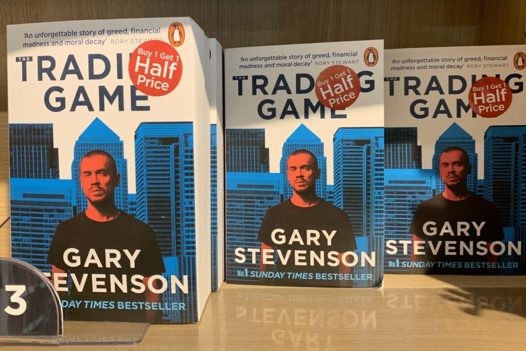 Photograph of multiple copies of The Trading Game by Gary Stevenson on display